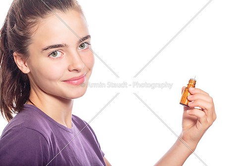 smiling woman is holding a bottle of homeopathic medicine, isola