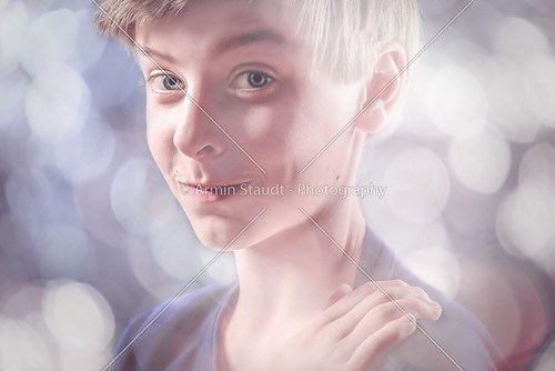 portrait of a lucky teenage boy, with bokeh around