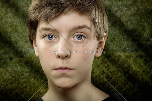 portrait of a teenager boy with scary green background