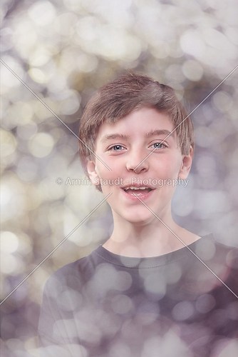 portrait of a lucky teenage boy, with bokeh around