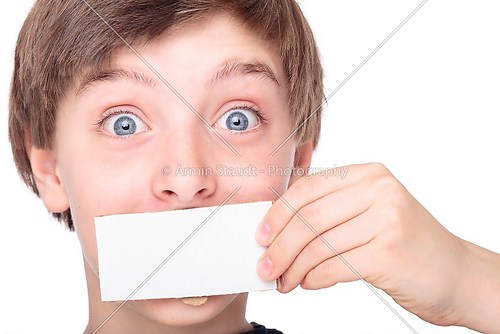portrait of a teenage boy holding a white piece of cardboard in 