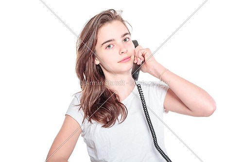 smiling teenager girl talking on the phone, isolated on white