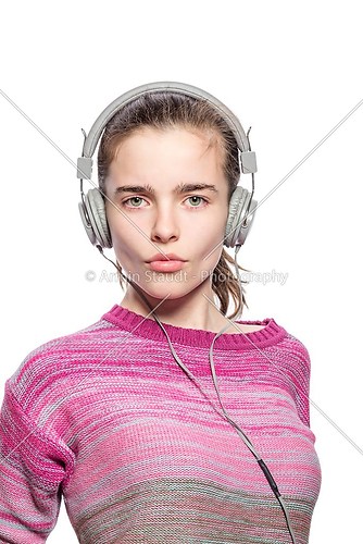 cool female teenager with headphones, isolated on white
