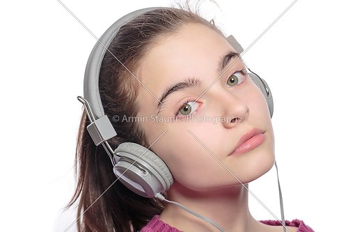 beautiful female teenager with earphones, isolated on white