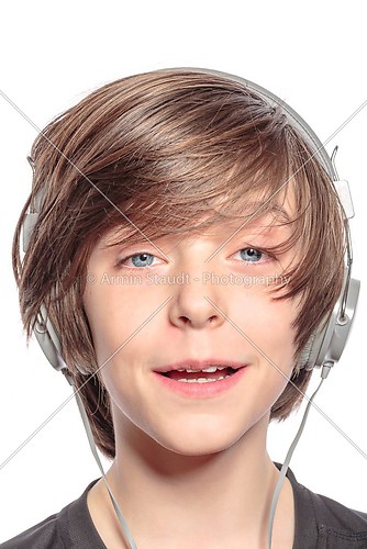 smiling cute teenager boy with headphones, isolated on white