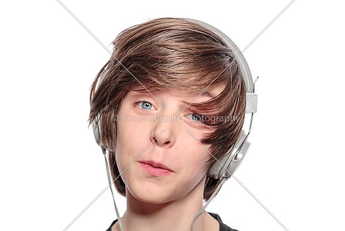 lucky teenage boy with headphones, isolated on white