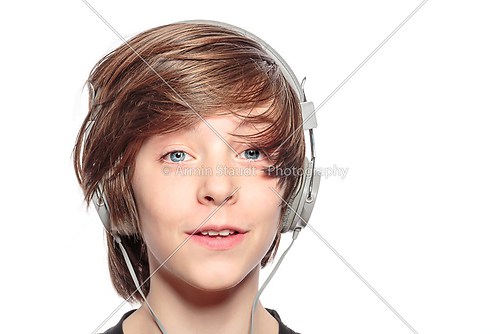 male smiling teenager with headphones, isolated on white