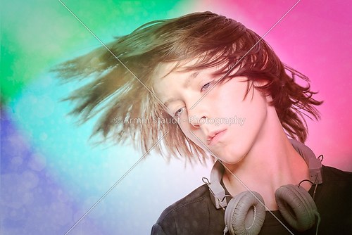 dancing male teenager with headphones and disco background