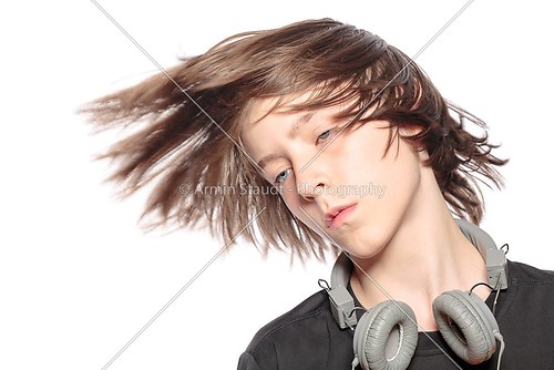 moving cool teenager boy with headphones, isolated on white