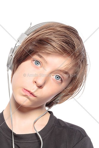 funny teenager boy with earphones, isolated on white
