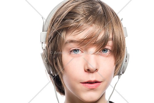 smiling cute teenager boy with headphones, isolated on white