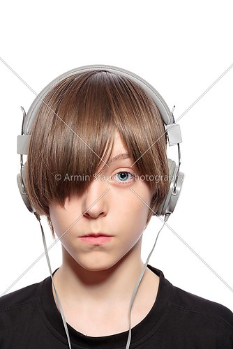 teenager boy with hair over one eye and headphones, isolated on 