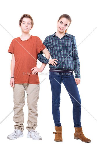 brother and sister standing with linked arms, isolated on white