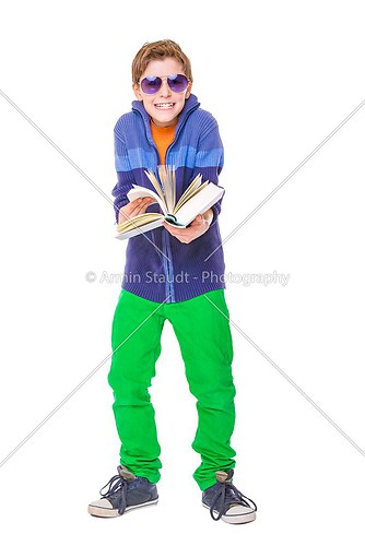 smiling teenager boy with sun glasses is holding a book, isolate