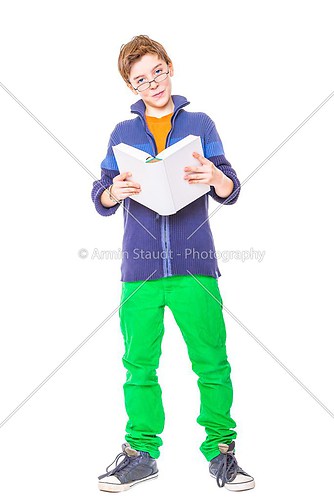 teenager boy with glasses reading a book, isolated on white