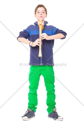 cool male teenager holding a flute, isolated on white
