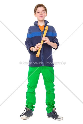 happy teenage boy is holding a flute, isolated on white