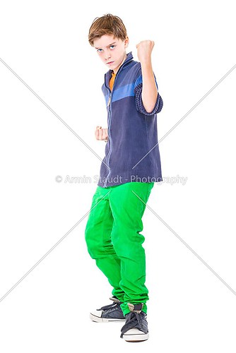 casual teenage boy is ready to fight isolated on white