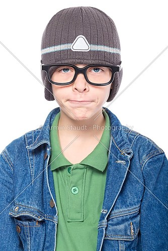 nerd looking teenage boy with glasses and cap, looking funny, is