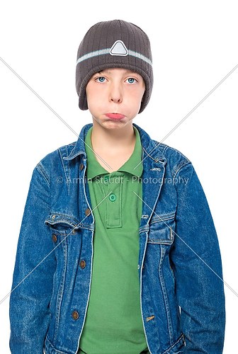 portrait of a sulking teenager boy with cap, isolated on white