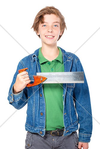 confident teenage boy holding a saw in one hand, isolated on whi
