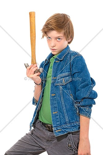 confident teenage boy holding the head of a hammer in one hand, 