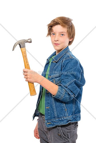 confident teenage boy holding a hammer on his shoulder, isolated