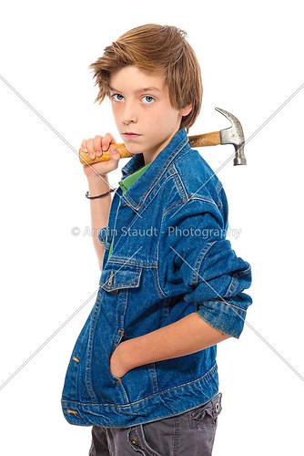 confident teenage boy holding a hammer on his shoulder, isolated