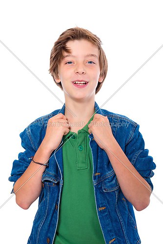 laughing teenage boy with hands on his jacked collar, isolated o
