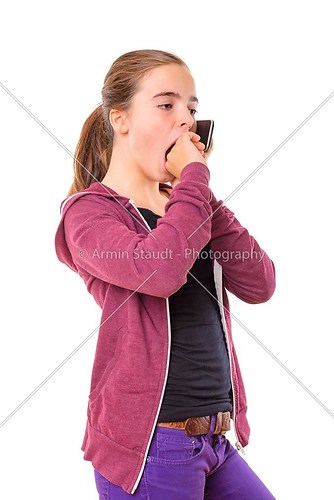 bored teenage girl speaking on mobile phone, yawning, isolated o