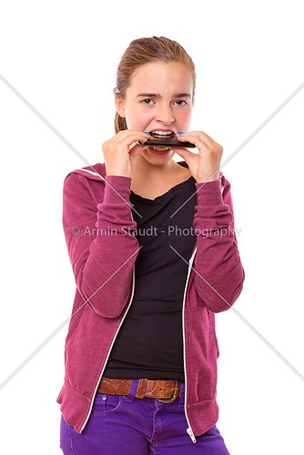 Desperate teenage girl biting in here mobile phone, , isolated o