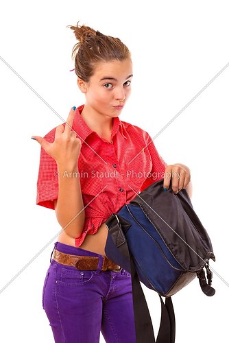 angry teenage girl holding a bag and  giving middle finger, isol