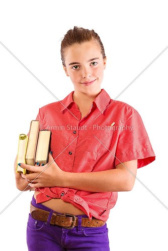 smiling teenage girl wearing some books, isolated on white