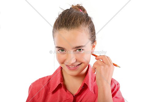 smiling teenage girl scratch with a pencil behind the ear, isola