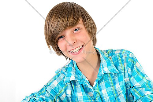 school boy is laughing into the camera, isolated on white