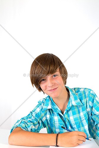 school boy is laughing into the camera, isolated on white