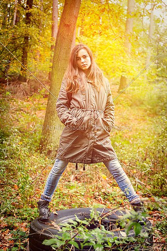 portrait of a beautiful teenage girl in an autumn forest