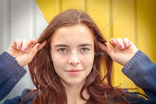 portrait of a teenage girl with fingers in the hair