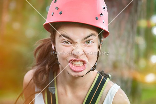 furious teenager girl with red climber helmet