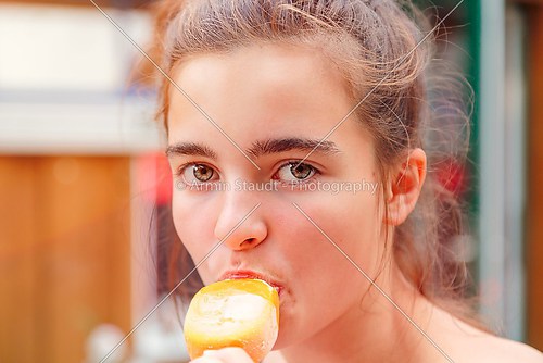 portrait of a teenage girl eating popsicle