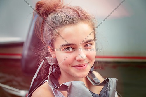 portrait of a smiling teenage girl with lifejacket