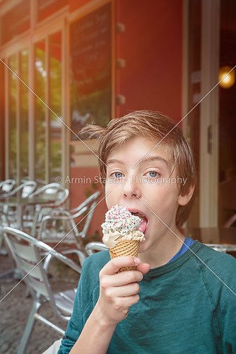 lucky teenager boy is eating his ice cream