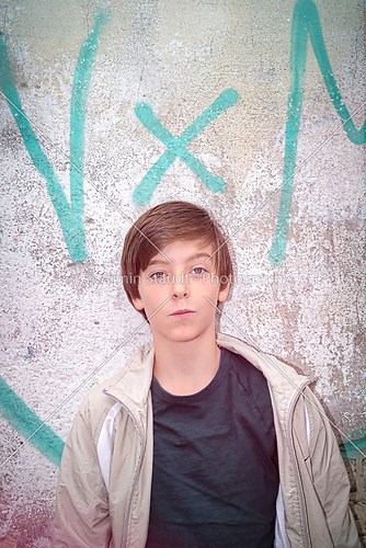 portrait of a teenager boy in front of a graffiti