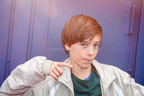 cool teenager boy pointing with his finger