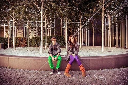 vintage style portrait of two teenager sitting in front of some 