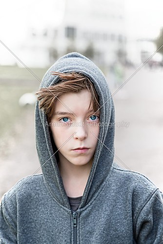 portrait of a teenage boy with grey hoodie sweatshirts