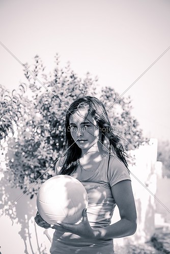 teenager girl holding a ball, black and white with color filter