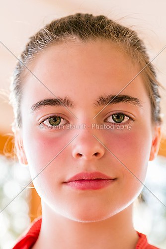 closeup portrait of a teenage girl with reddened cheeks