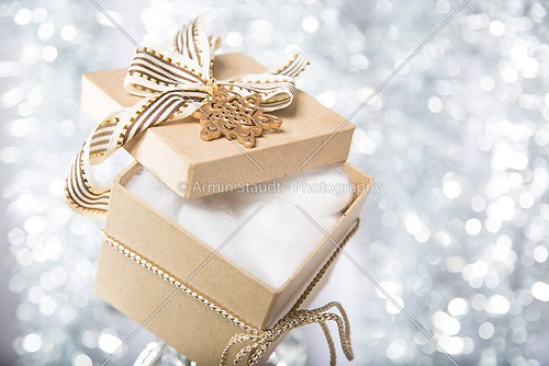 open christmas gift box with cotton wool, ribbon and bow