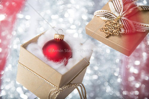 open gift box with christmas ball, ribbon and bow